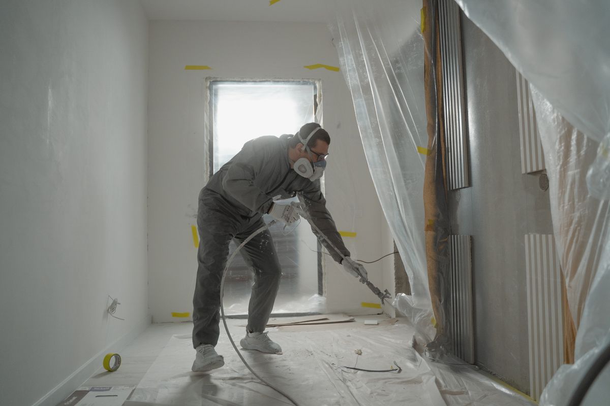 Contractor priming the walls
